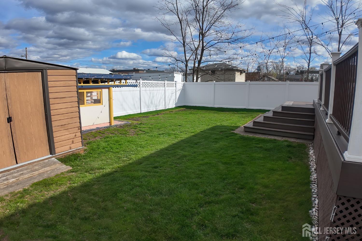 202 Jackson Avenue Edison, NJ 08837 - Photo 19 of 35 a view of a backyard with wooden fence