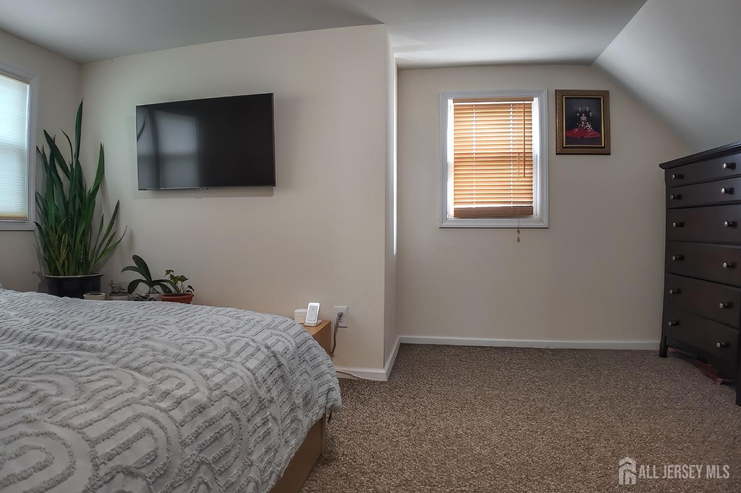 202 Jackson Avenue Edison, NJ 08837 - Photo 21 of 35 a bedroom with a bed and a flat screen tv