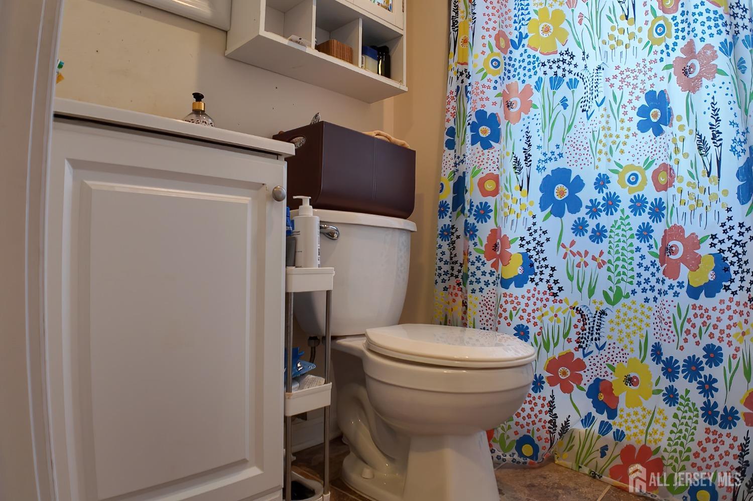 202 Jackson Avenue Edison, NJ 08837 - Photo 23 of 35 a white toilet sitting next to a shower curtain