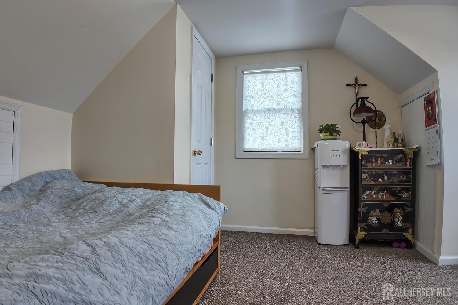 202 Jackson Avenue Edison, NJ 08837 - Photo 24 of 35 a bed sitting in a bedroom next to a window