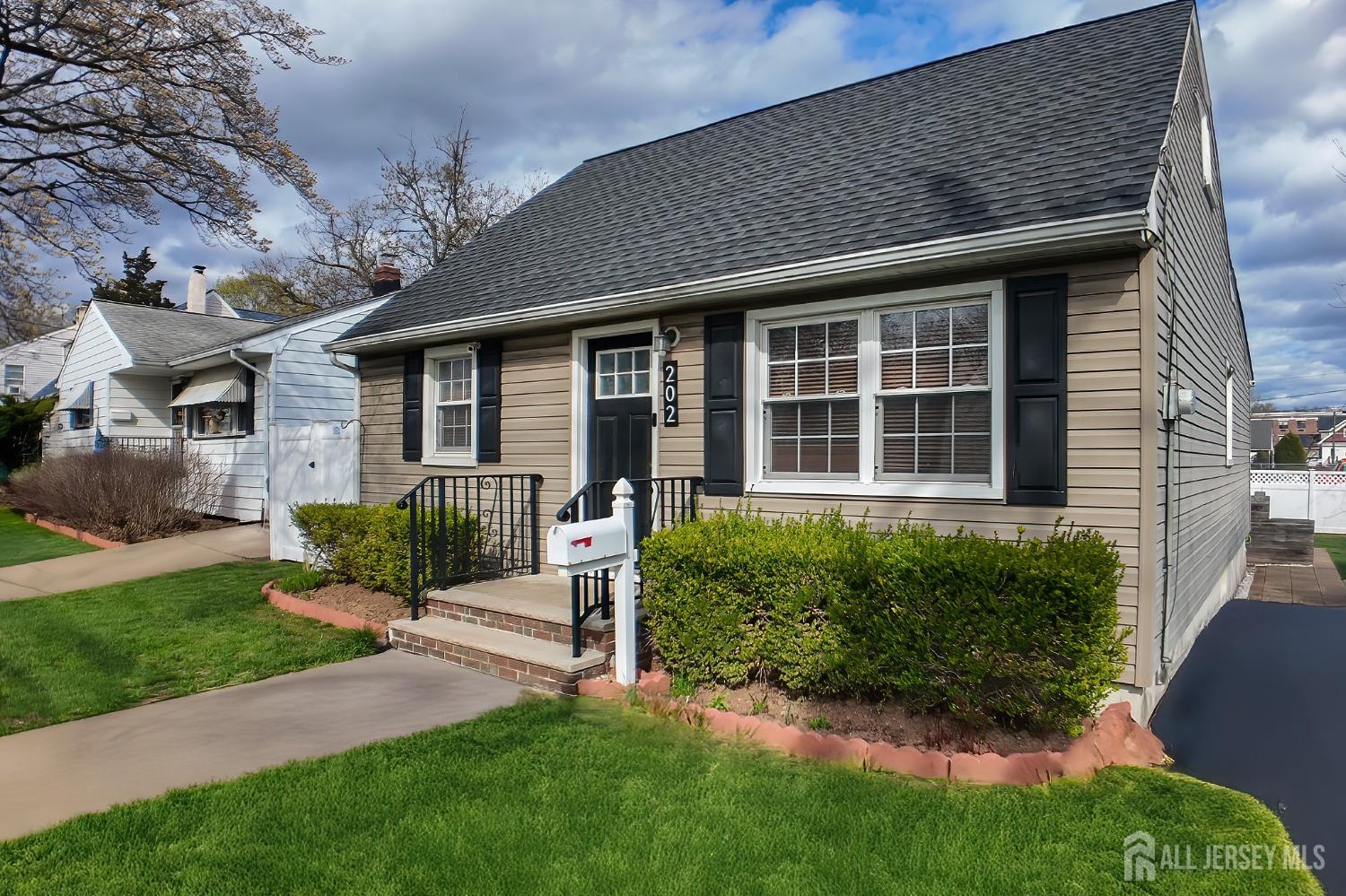 202 Jackson Avenue Edison, NJ 08837 - Photo 3 of 35 a front view of a house with a yard and outdoor seating