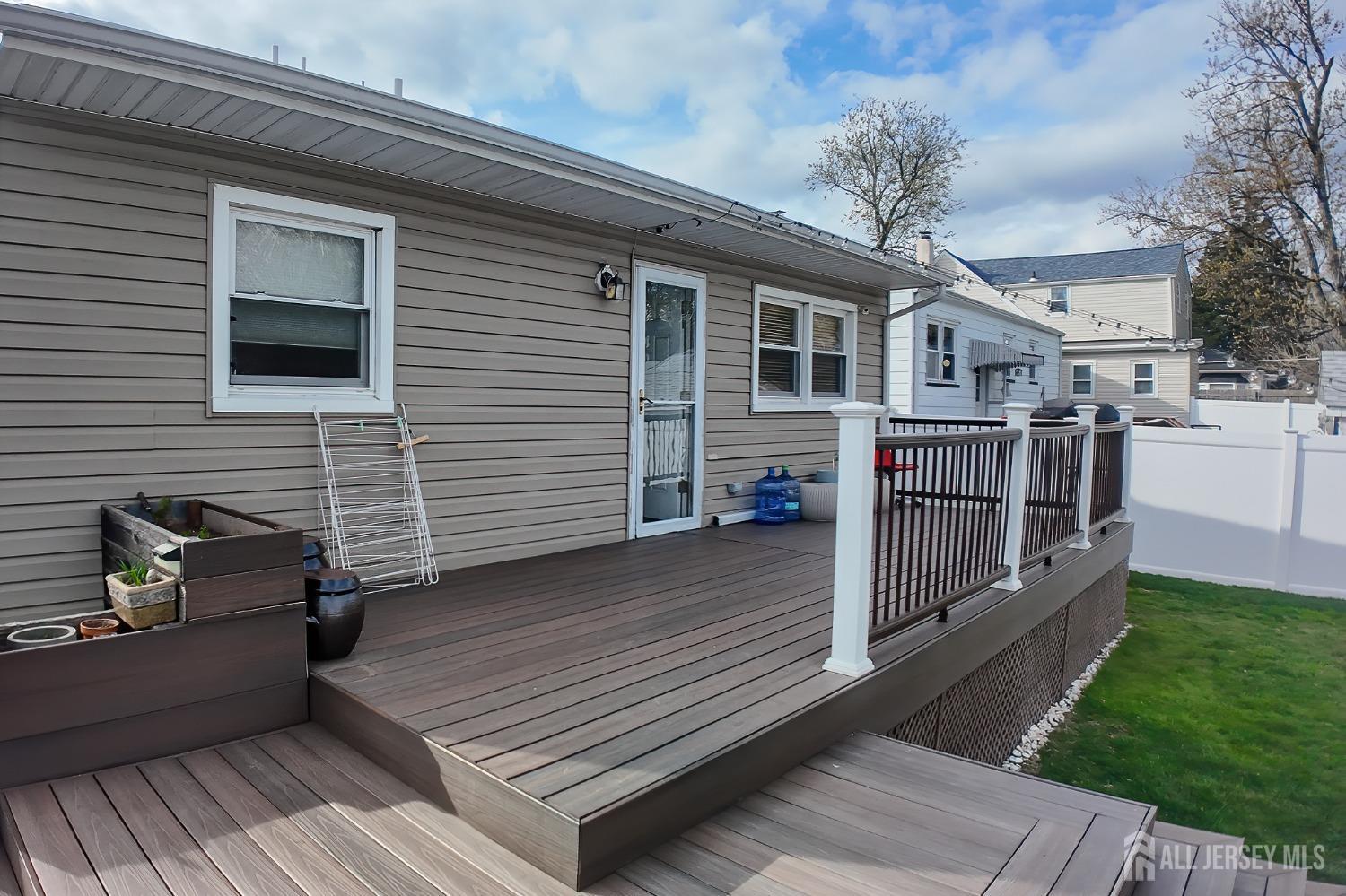202 Jackson Avenue Edison, NJ 08837 - Photo 33 of 35 a view of a deck with couches wooden floor and fence