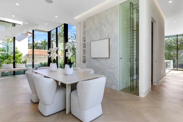 a dining room with furniture and wooden floor