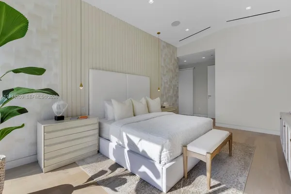 a bedroom with a bed and a painting on the wall