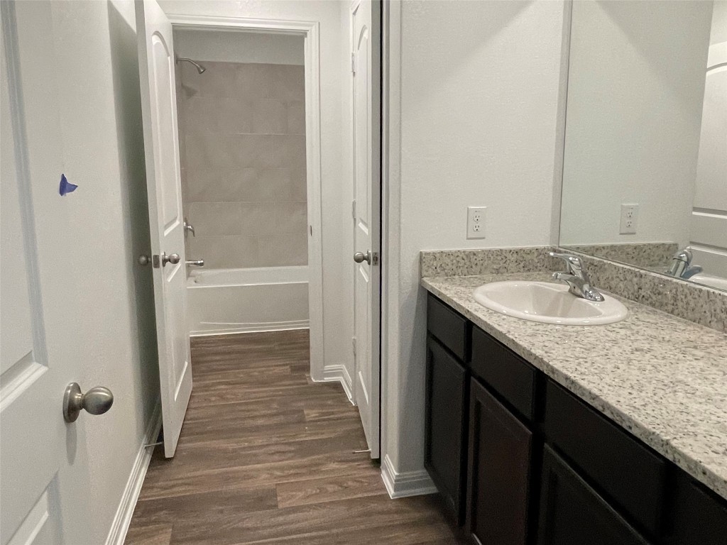112 Dupont Pass Jarrell, TX 76537 - Photo 13 of 17 a bathroom with a granite countertop sink