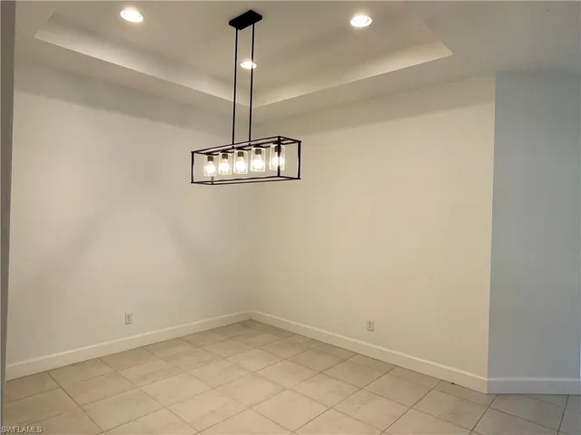 an empty room with white walls and tiles