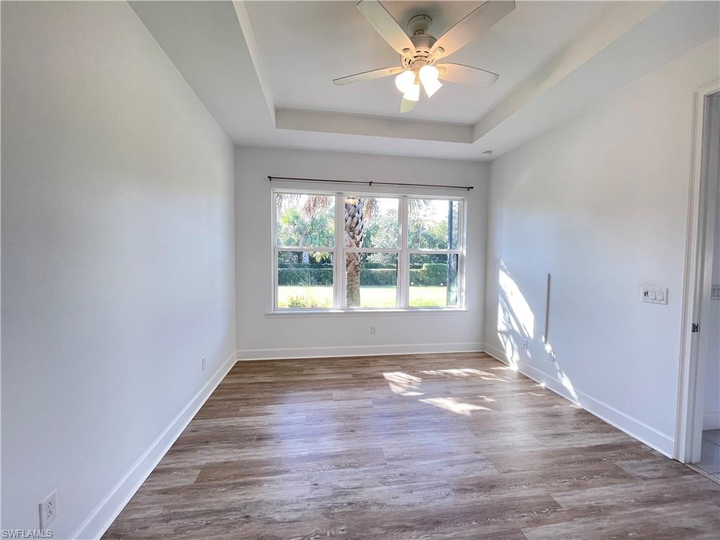 8217 Lucello Terrace West Naples, FL 34114 - Photo 16 of 41 a view of empty room with wooden floor and fan