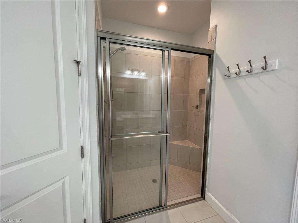 8217 Lucello Terrace West Naples, FL 34114 - Photo 17 of 41 a bathroom with a glass shower door