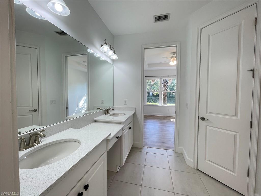 8217 Lucello Terrace West Naples, FL 34114 - Photo 19 of 41 a bathroom with a sink double vanity and a mirror