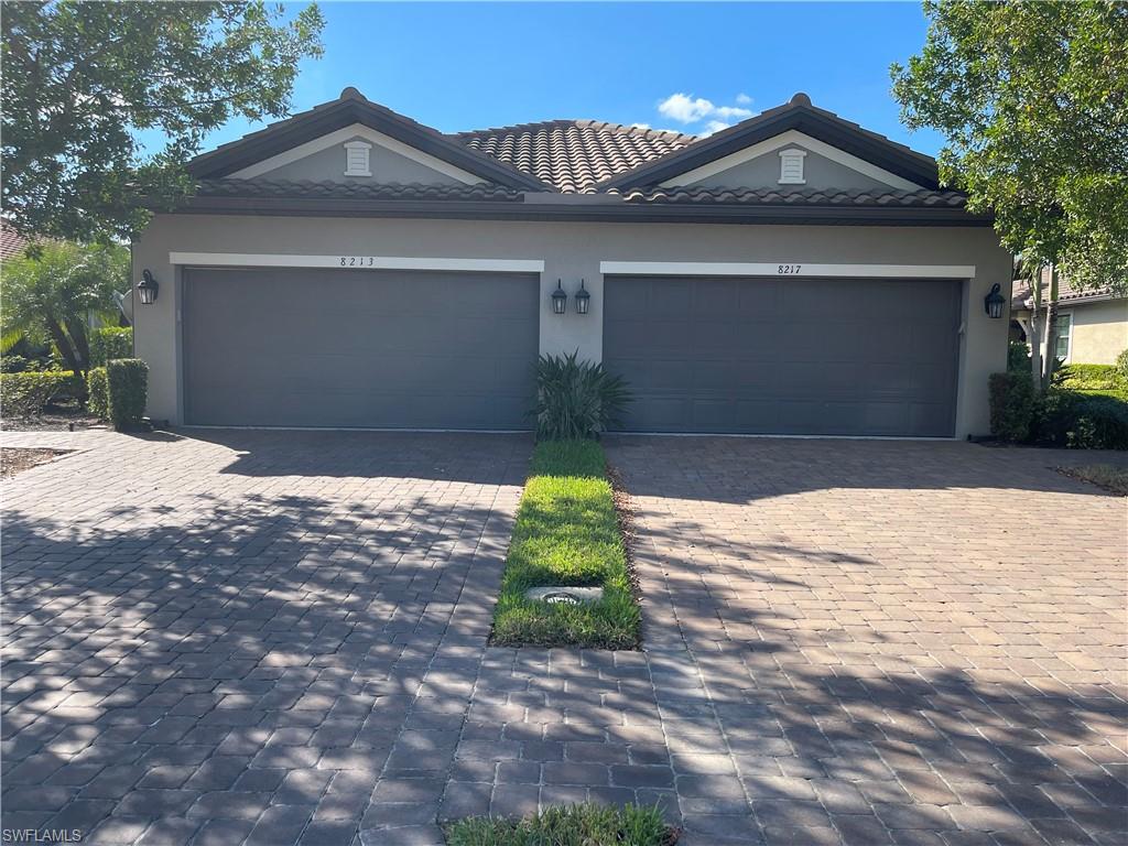 8217 Lucello Terrace West Naples, FL 34114 - Photo 2 of 41 a front view of a house with garden