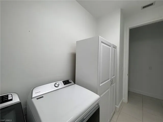 a front view of multi story residential apartment building with yard and green space