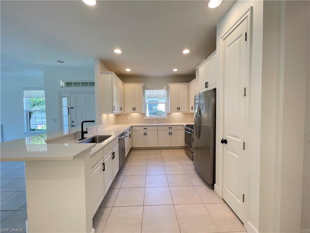 8217 Lucello Terrace West Naples, FL 34114 - Photo 4 of 41 a large kitchen with a stove a sink and a refrigerator
