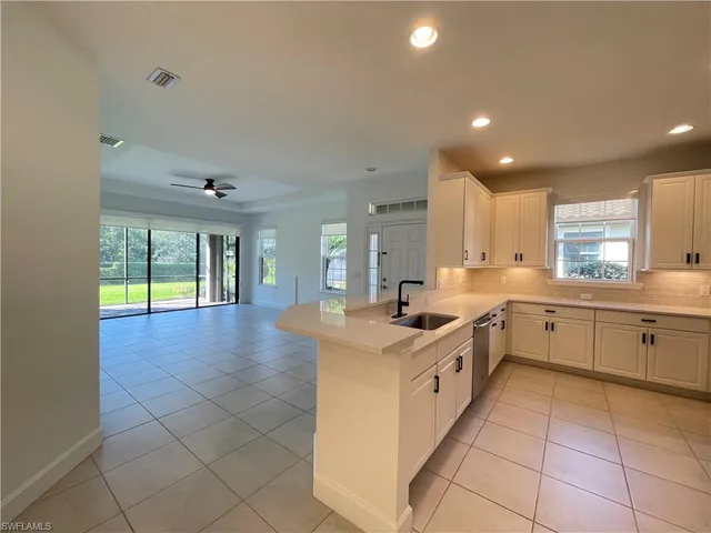 a kitchen with a sink and cabinets