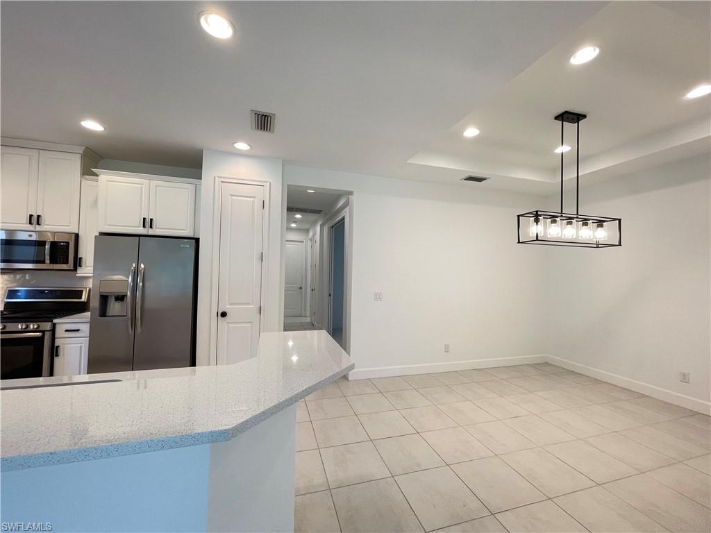 8217 Lucello Terrace West Naples, FL 34114 - Photo 8 of 41 a kitchen with stainless steel appliances a refrigerator and a sink