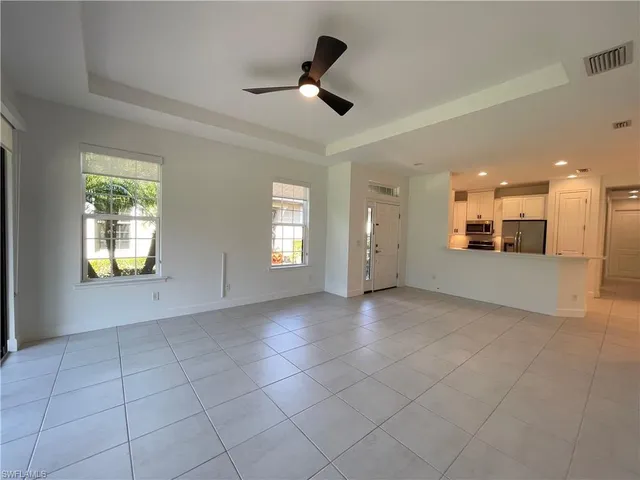 a view of a livingroom with a ceiling fan and window