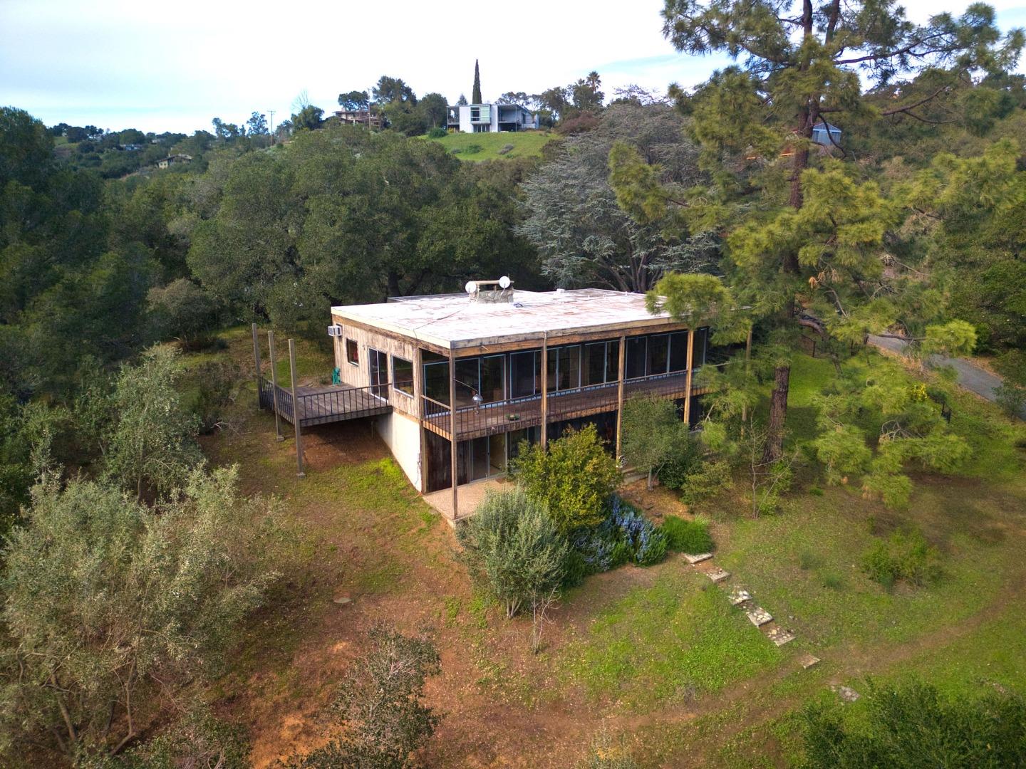 26969 Moody Road Los Altos Hills, CA 94022 - Photo 1 of 52 a view of a house with a big yard and large trees