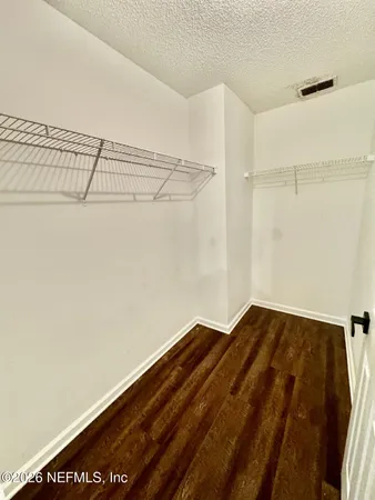 a view of a room with wooden floor