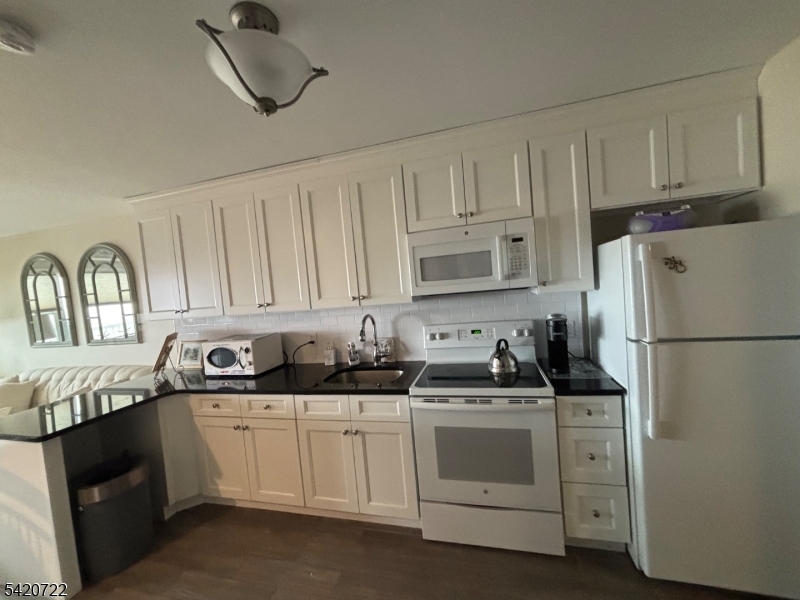 1935 Oceanfront, Unit 20 Seaside Heights, NJ 08751 - Photo 11 of 16 a kitchen with appliances a sink and cabinets