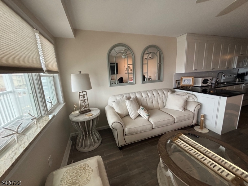 1935 Oceanfront, Unit 20 Seaside Heights, NJ 08751 - Photo 15 of 16 a living room with furniture and a fireplace