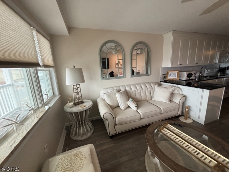 1935 Oceanfront, Unit 20 Seaside Heights, NJ 08751 - Photo 2 of 16 a living room with furniture and a fireplace