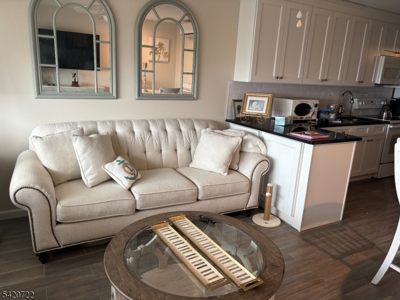 1935 Oceanfront, Unit 20 Seaside Heights, NJ 08751 - Photo 4 of 16 a living room with furniture and a couch