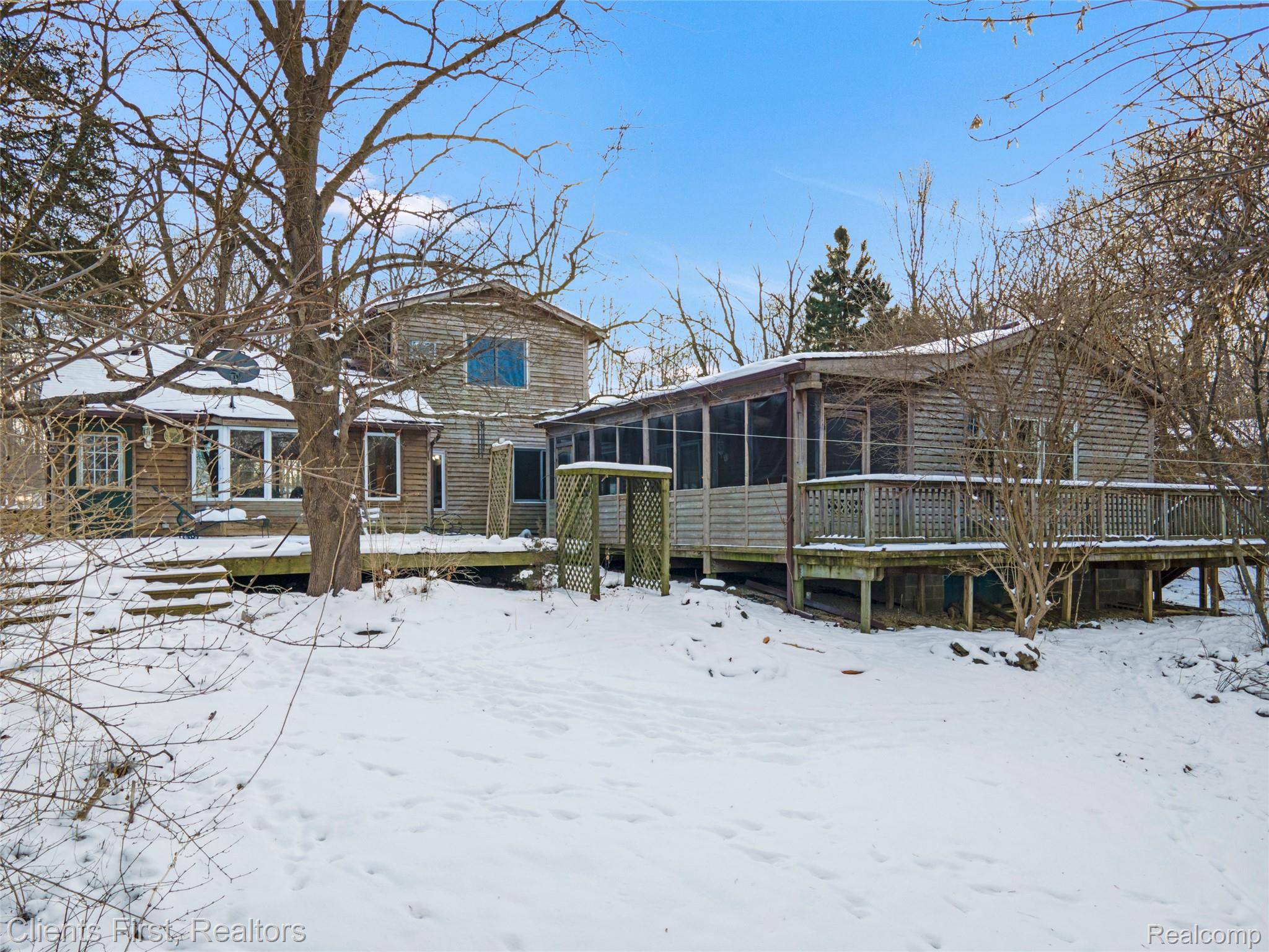 9985 Ford Road Ypsilanti, MI 48198 - Photo 47 of 58 View of back of property featuring a wooden deck and a screen porch