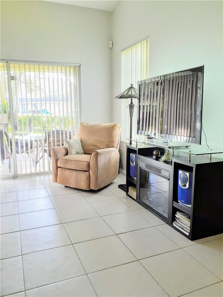 2 Glamis Way, Unit 2 Boynton Beach, FL 33426 - Photo 13 of 19 a living room with furniture and a floor to ceiling window
