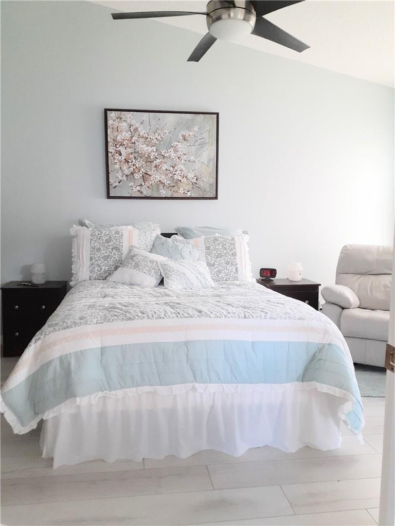 2 Glamis Way, Unit 2 Boynton Beach, FL 33426 - Photo 14 of 19 a bedroom with a bed and a painting on the wall