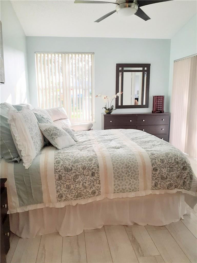 2 Glamis Way, Unit 2 Boynton Beach, FL 33426 - Photo 15 of 19 a bedroom with a large bed and a dresser