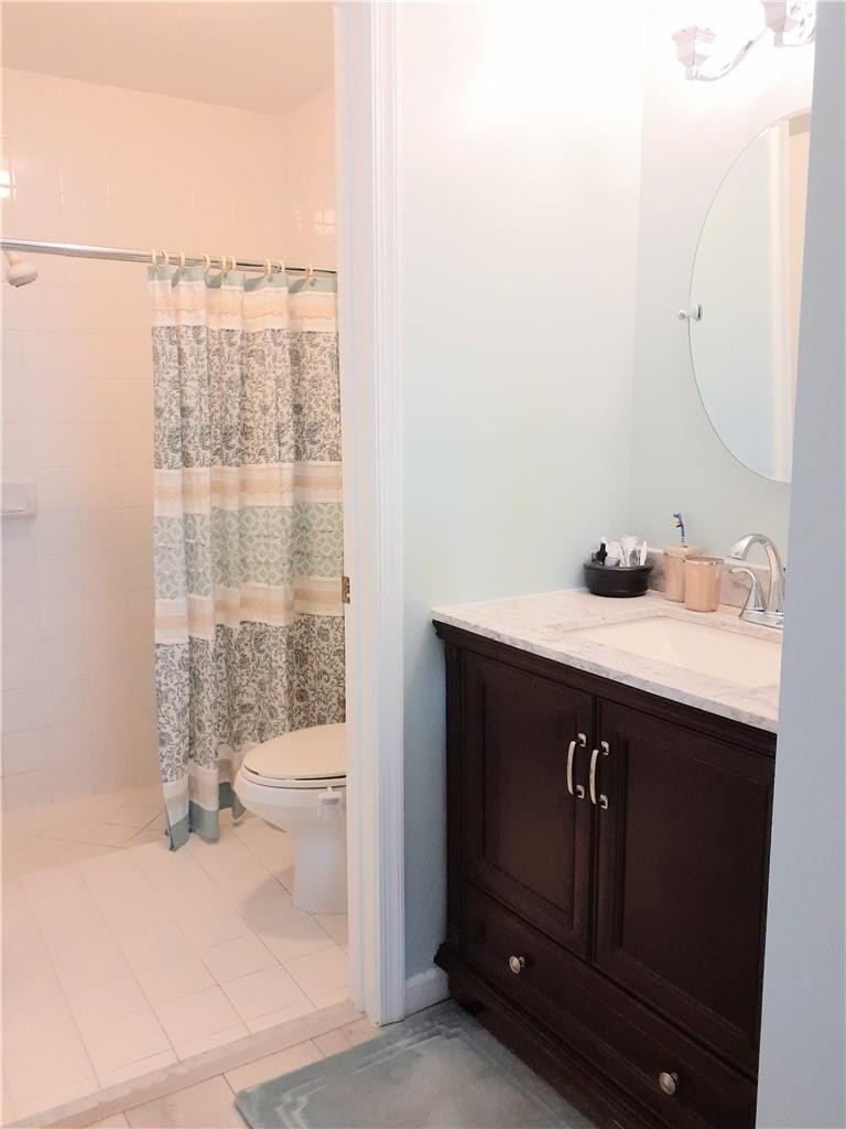 2 Glamis Way, Unit 2 Boynton Beach, FL 33426 - Photo 17 of 19 a bathroom with a sink a toilet and shower