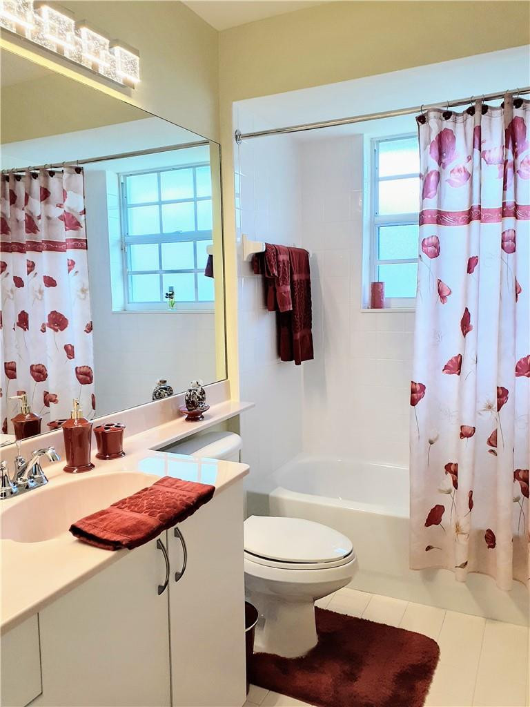 2 Glamis Way, Unit 2 Boynton Beach, FL 33426 - Photo 18 of 19 a bathroom with a sink toilet and shower