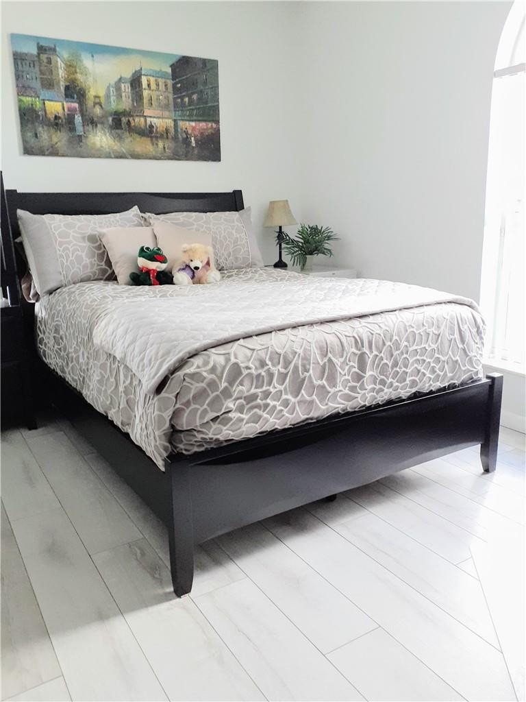 2 Glamis Way, Unit 2 Boynton Beach, FL 33426 - Photo 19 of 19 a bedroom with a bed and painting on the wall