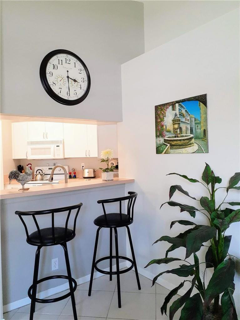 2 Glamis Way, Unit 2 Boynton Beach, FL 33426 - Photo 9 of 19 a view of a dining room with furniture and window