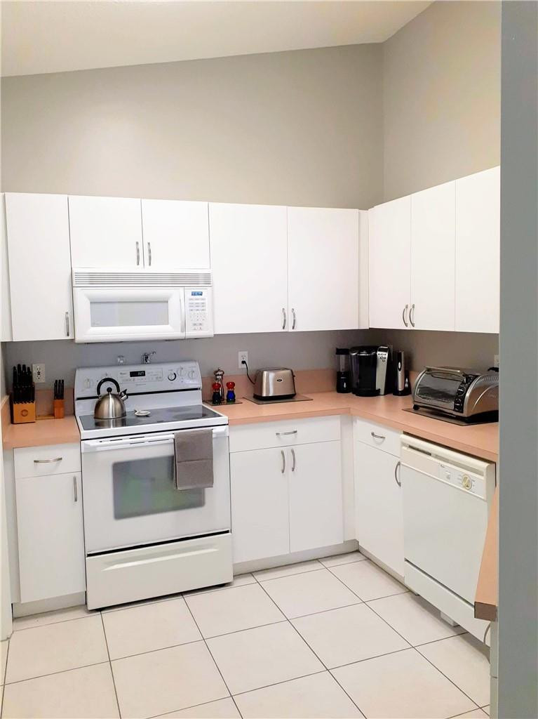 2 Glamis Way, Unit 2 Boynton Beach, FL 33426 - Photo 10 of 19 a kitchen with cabinets appliances a sink and a window