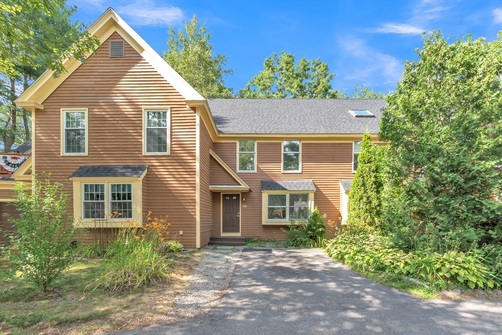 111 Brigham Street, Unit 13B Hudson, MA 01749 - Photo 1 of 23 a view of a house with a yard