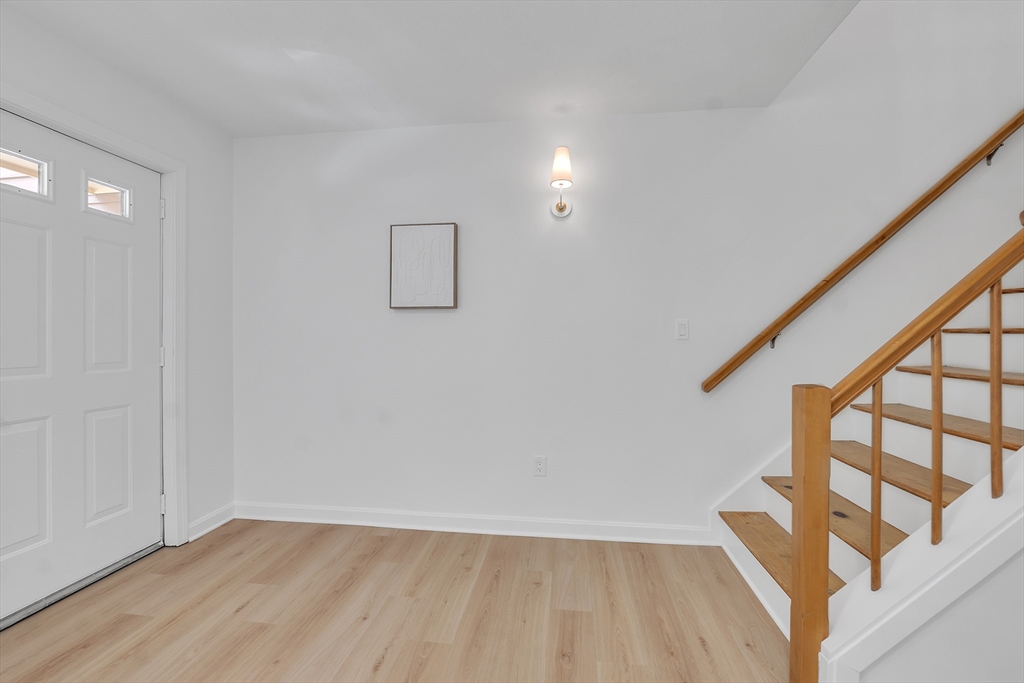 111 Brigham Street, Unit 13B Hudson, MA 01749 - Photo 11 of 23 a view of an entryway with wooden floor