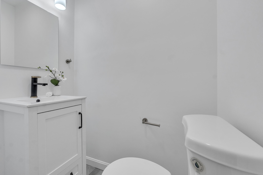 111 Brigham Street, Unit 13B Hudson, MA 01749 - Photo 12 of 23 a bathroom with a sink a toilet and mirror
