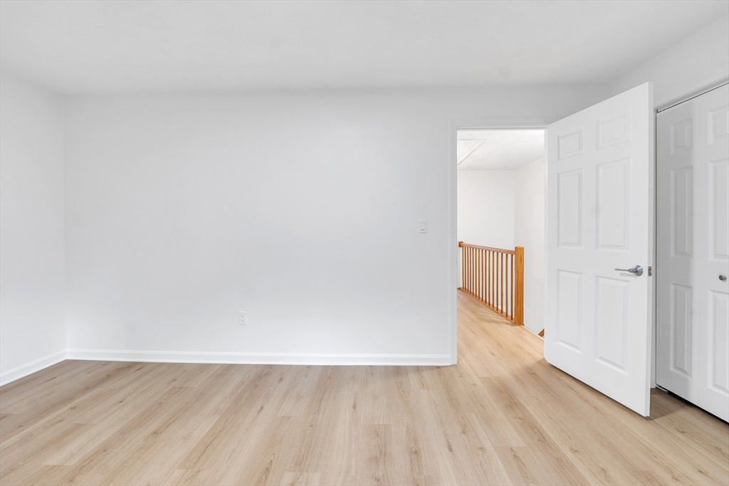 111 Brigham Street, Unit 13B Hudson, MA 01749 - Photo 15 of 23 a view of an empty room and wooden floor