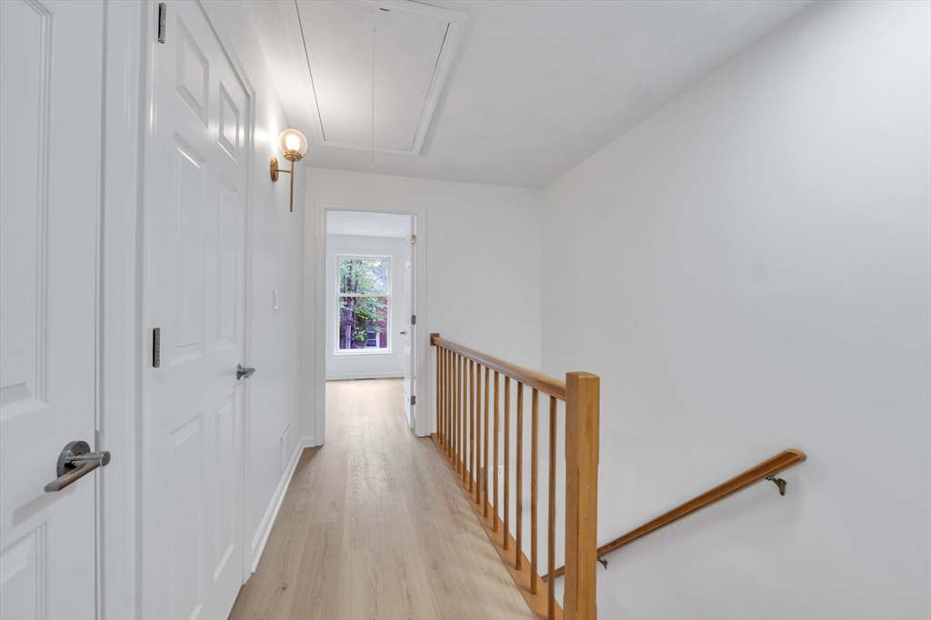111 Brigham Street, Unit 13B Hudson, MA 01749 - Photo 16 of 23 a view of a hallway with a dining area