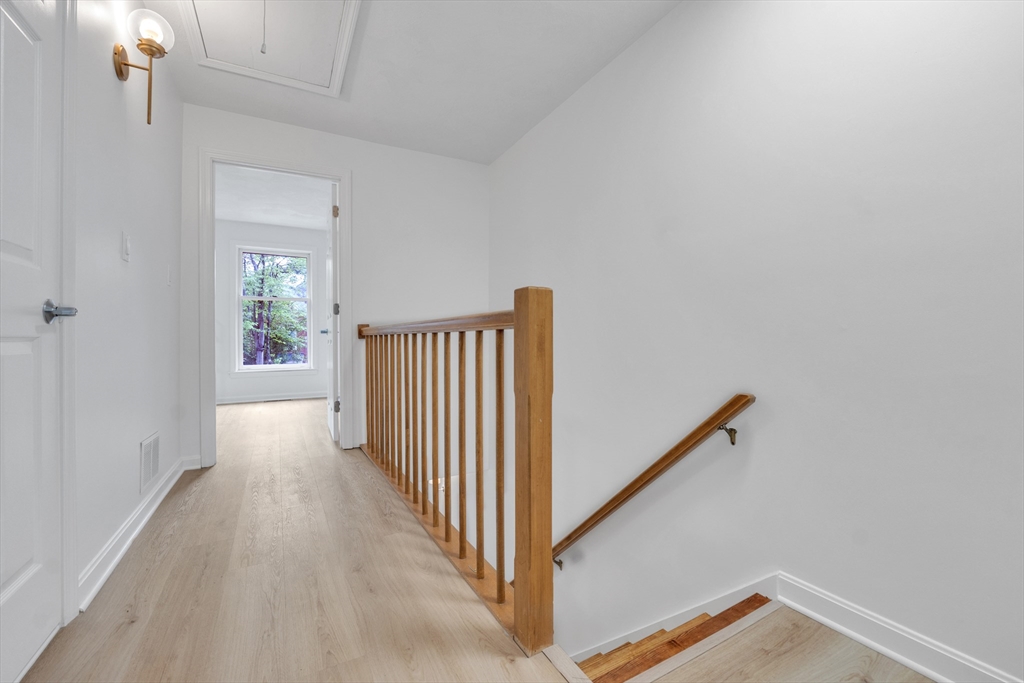 111 Brigham Street, Unit 13B Hudson, MA 01749 - Photo 19 of 23 a view of a hallway with wooden floor