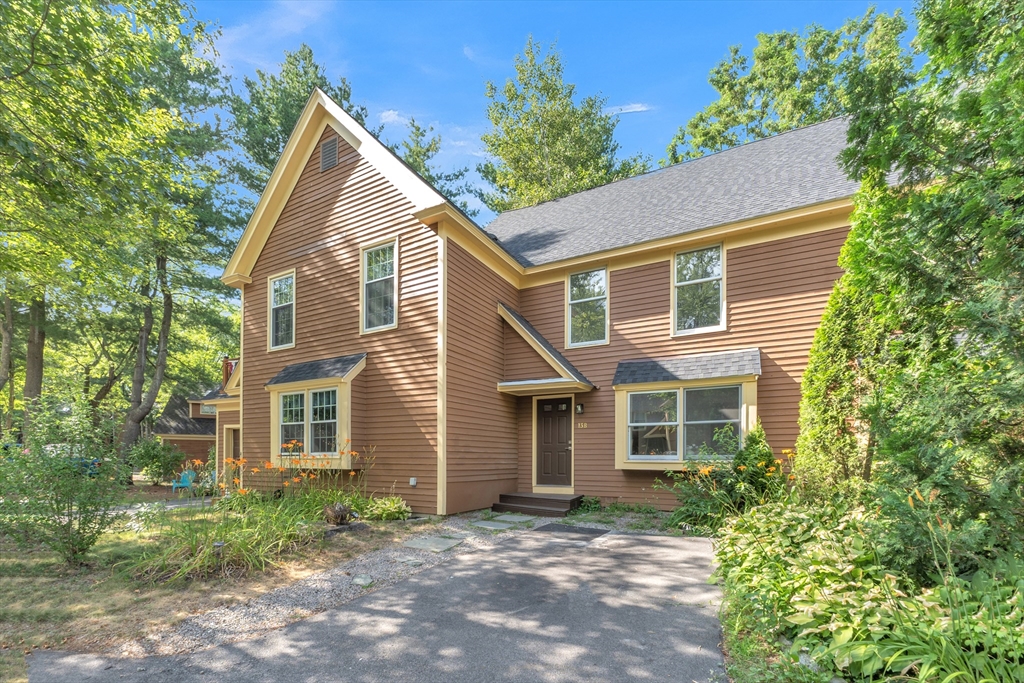111 Brigham Street, Unit 13B Hudson, MA 01749 - Photo 2 of 23 a view of a house with a yard