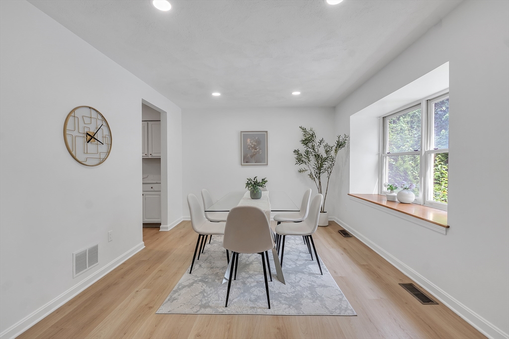 111 Brigham Street, Unit 13B Hudson, MA 01749 - Photo 3 of 23 a view of a dining room with furniture window and wooden floor