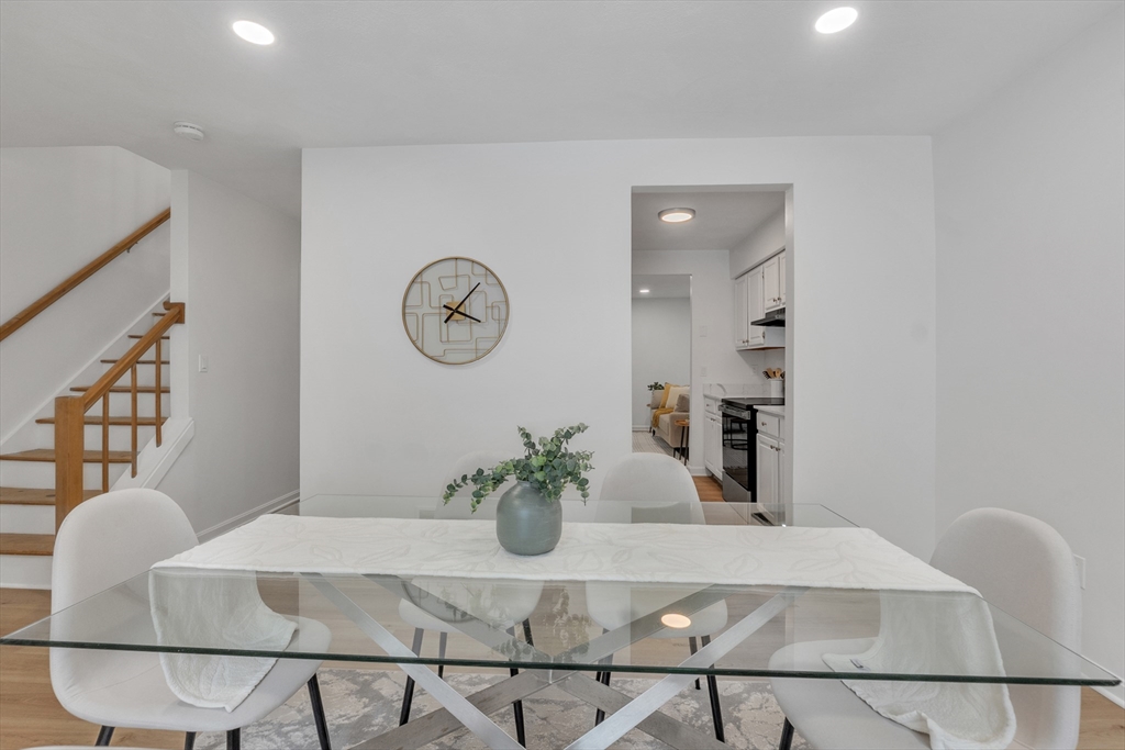 111 Brigham Street, Unit 13B Hudson, MA 01749 - Photo 4 of 23 a dining room with furniture and wooden floor