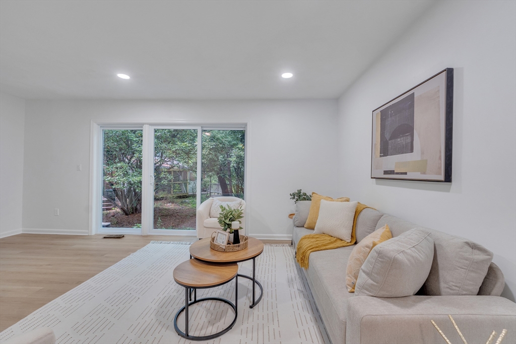 111 Brigham Street, Unit 13B Hudson, MA 01749 - Photo 7 of 23 a living room with furniture and a large window