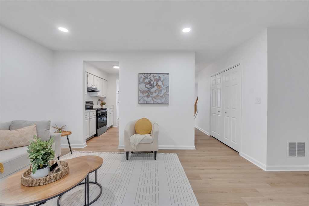 111 Brigham Street, Unit 13B Hudson, MA 01749 - Photo 8 of 23 a living room with furniture and wooden floor
