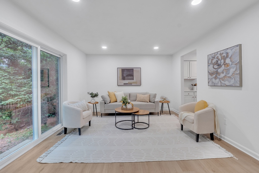 111 Brigham Street, Unit 13B Hudson, MA 01749 - Photo 9 of 23 a living room with furniture and a rug