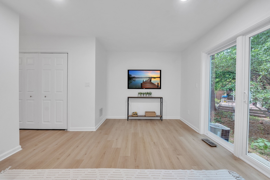 111 Brigham Street, Unit 13B Hudson, MA 01749 - Photo 10 of 23 a living room with furniture and a flat screen tv