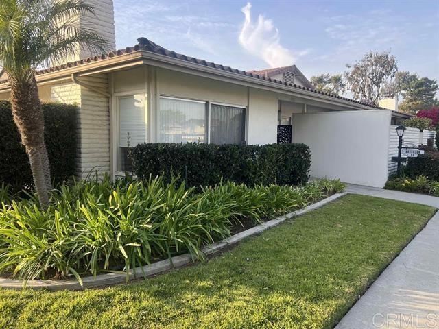 7061 Estrella De Mar Road, Unit 66 Carlsbad, CA 92009 - Photo 1 of 17 a front view of a house with a yard