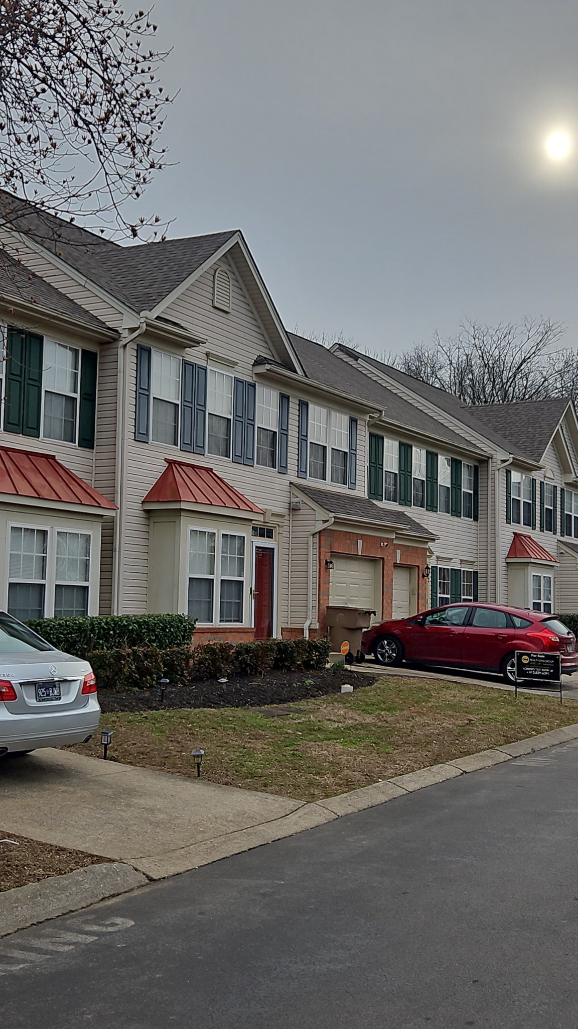 a front view of building with cars parked