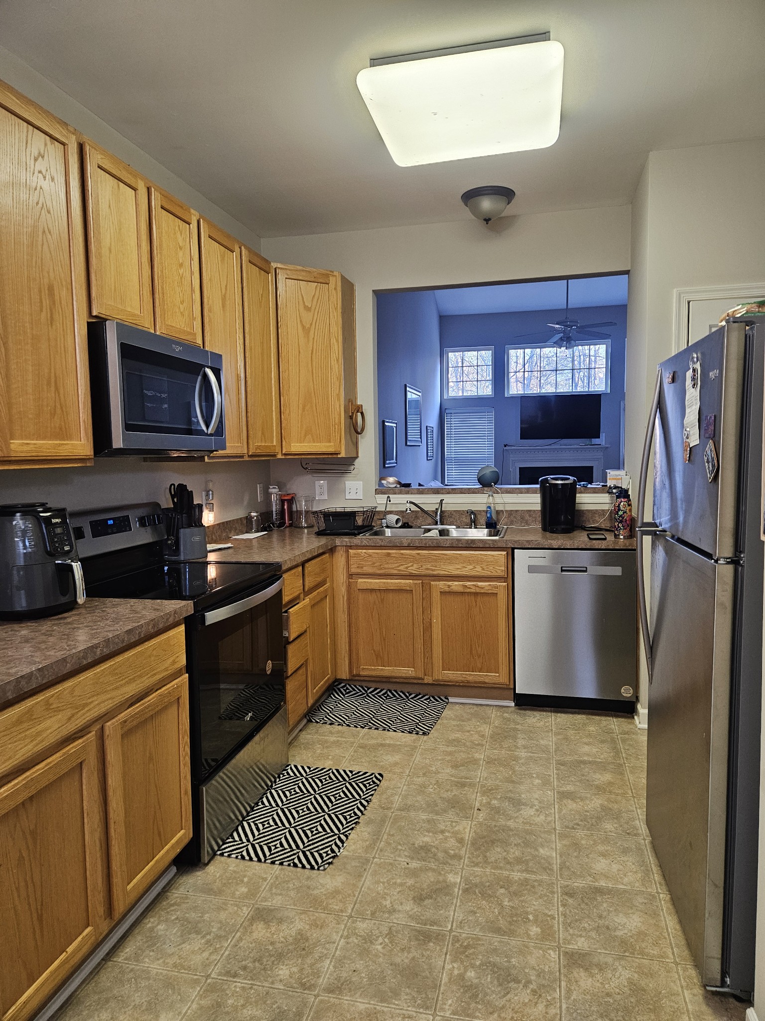 3401 Anderson Road, Unit 34 Antioch, TN 37013 - Photo 3 of 23 a kitchen with stainless steel appliances granite countertop a stove a sink dishwasher a refrigerator and a microwave